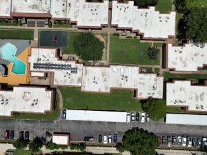 Apartment roofing contractors DFW inspecting multi-family property